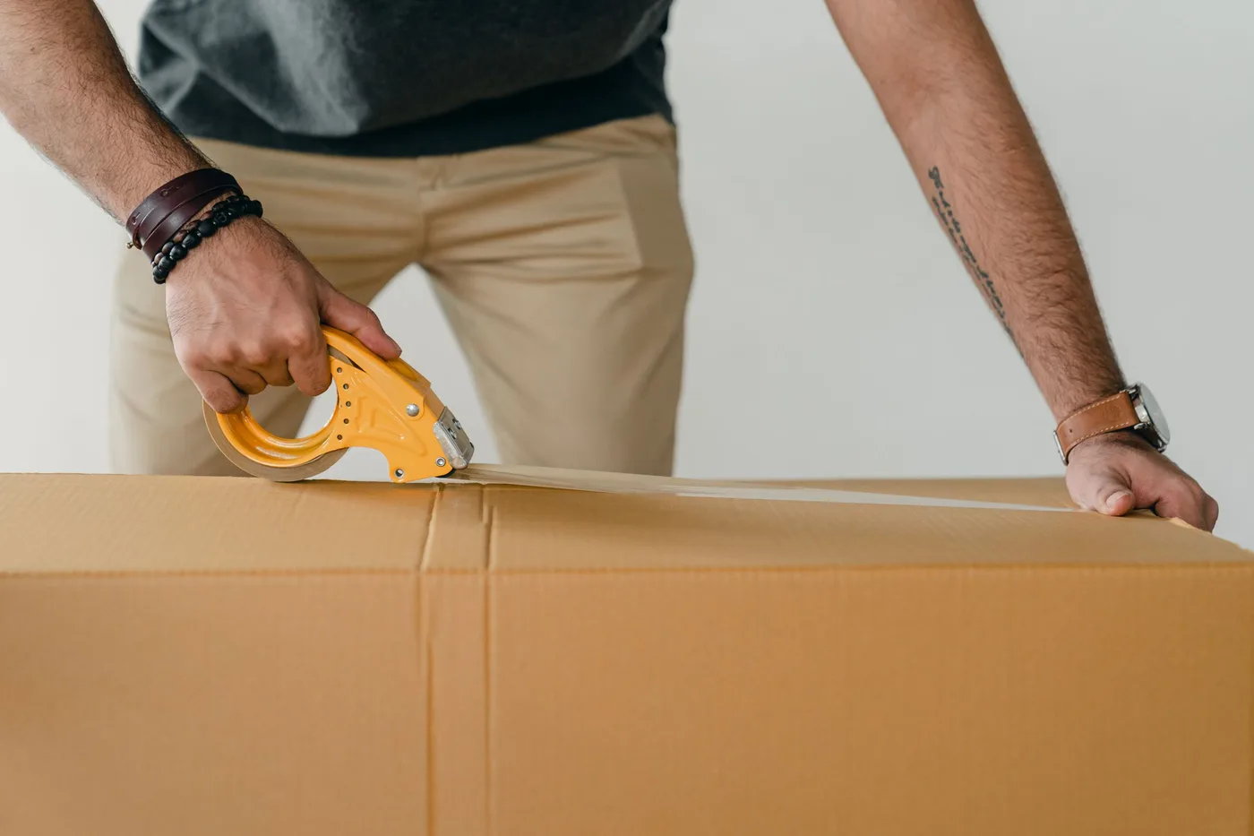 Sealing a kraft box with a tape gun before dispatch